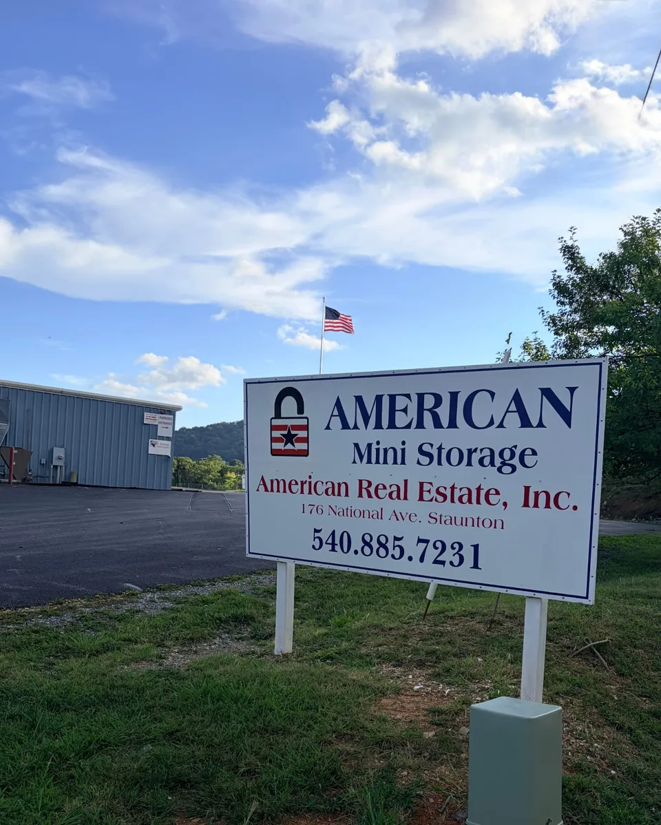 American Mini Storage roadside sign at 176 National Ave, Staunton VA, with the rental office and American flag behind it, serving Mint Spring, VA